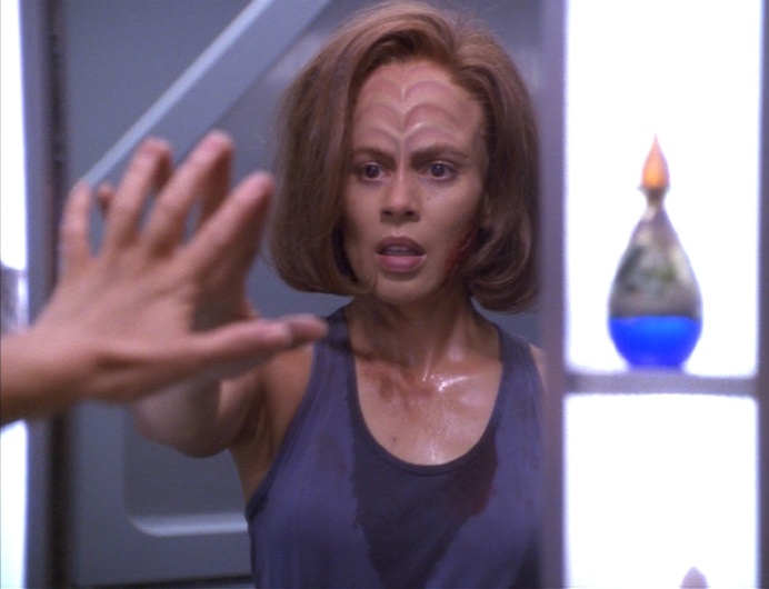 B'Elanna looks at herself in the mirror in her quarters