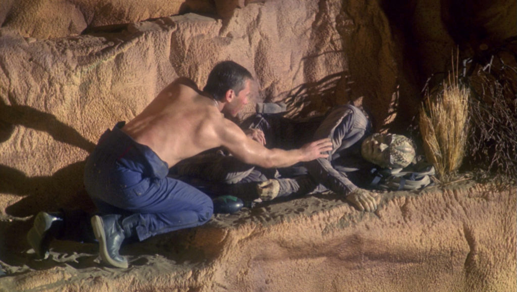 Tucker and Zho'Kaan, the pilot stranded with him, as Zho'Kaan nears death on the mountain.